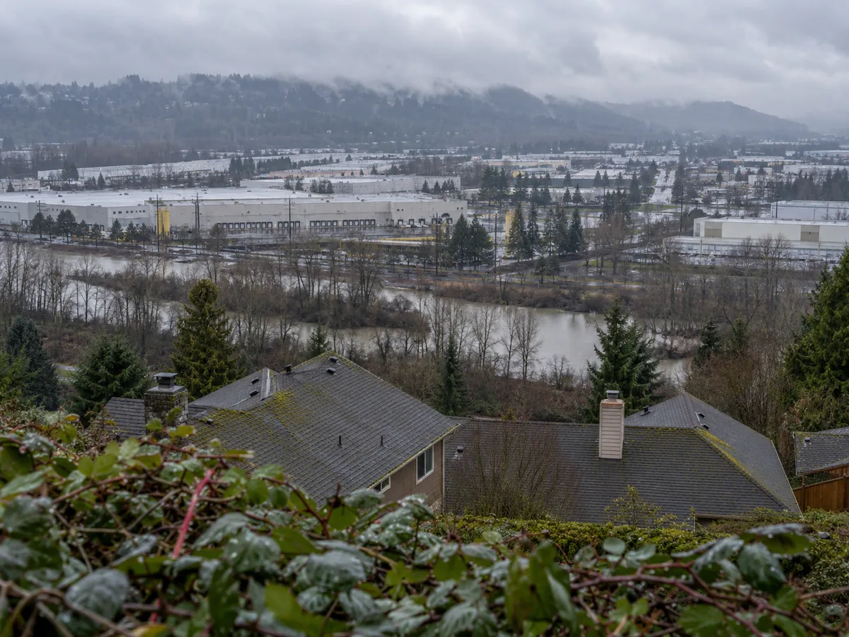 The Kent, WA valley floor from the East Hill bluff: the warehouse corridor between the two Valley Highways, West Hill beyond